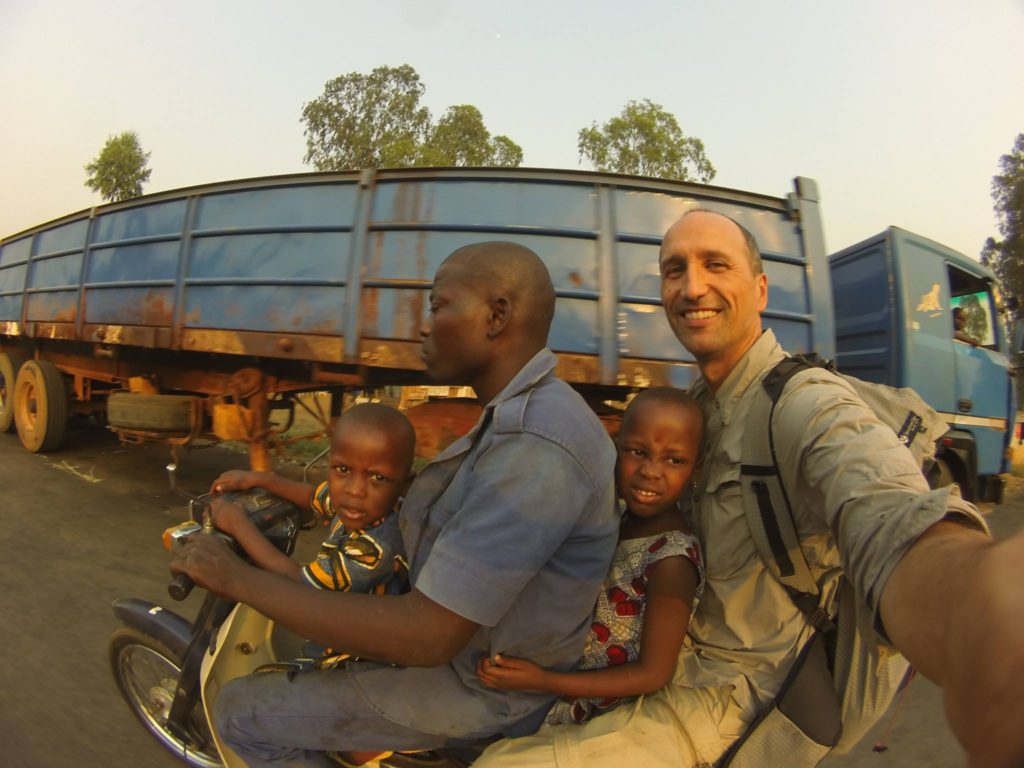 Francis riding with a scooter in Africa